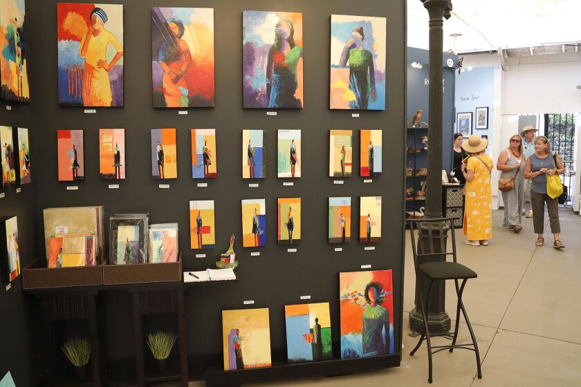 Tim Genet's figures of mixed media oil paintings on display at Laguna's Art-A-Fair festival.
