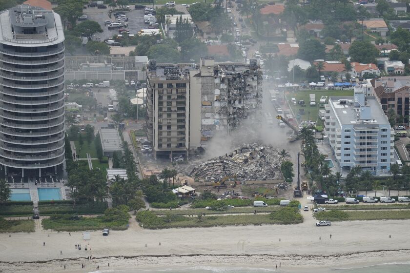 Rescue workers work in the rubble at the Champlain Towers South Condo is seen, Friday, June 25, 2021, in Surfside. The apartment building partially collapsed on Thursday. (AP Photo/Gerald Herbert)