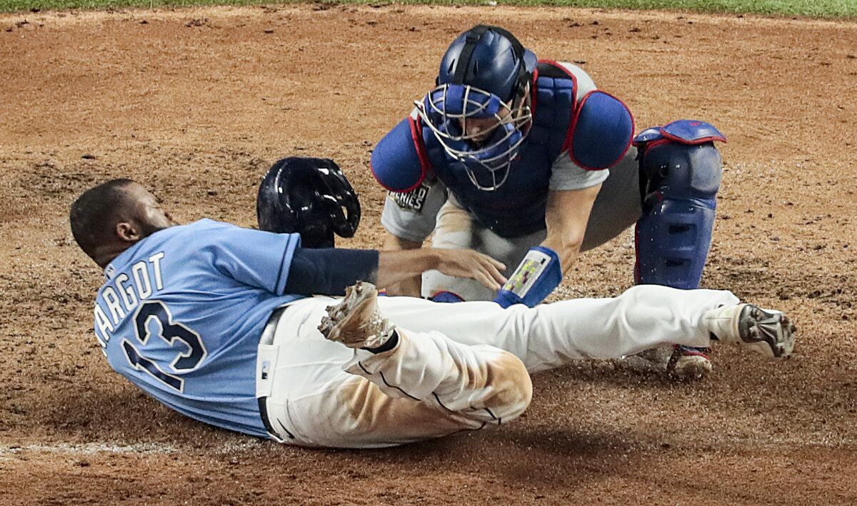 Dodgers catcher Austin Barnes tags Tampa Bay Rays baserunner Manuel Margot as he tries to steal home in Game 5.