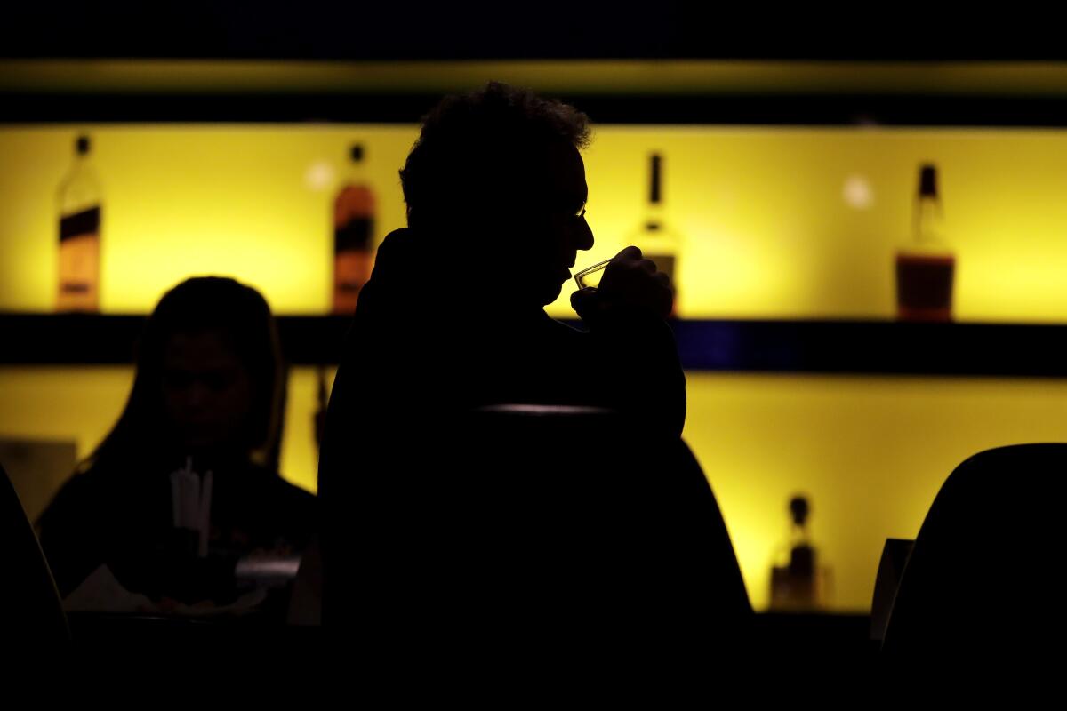 A patron sips his drink at a bar in New Jersey. 