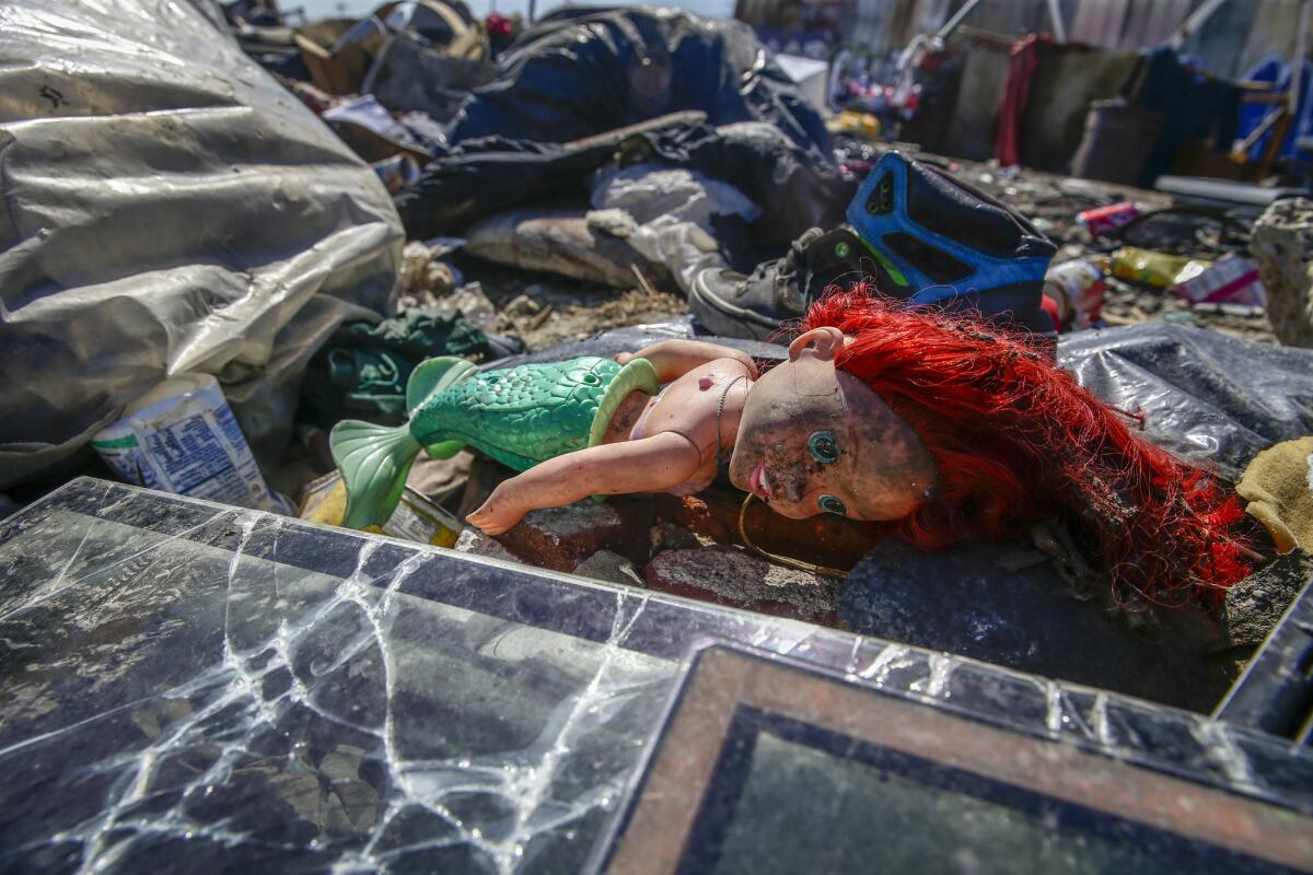 Piles of trash remain near 25th Street and Long Beach Avenue in Los Angeles.