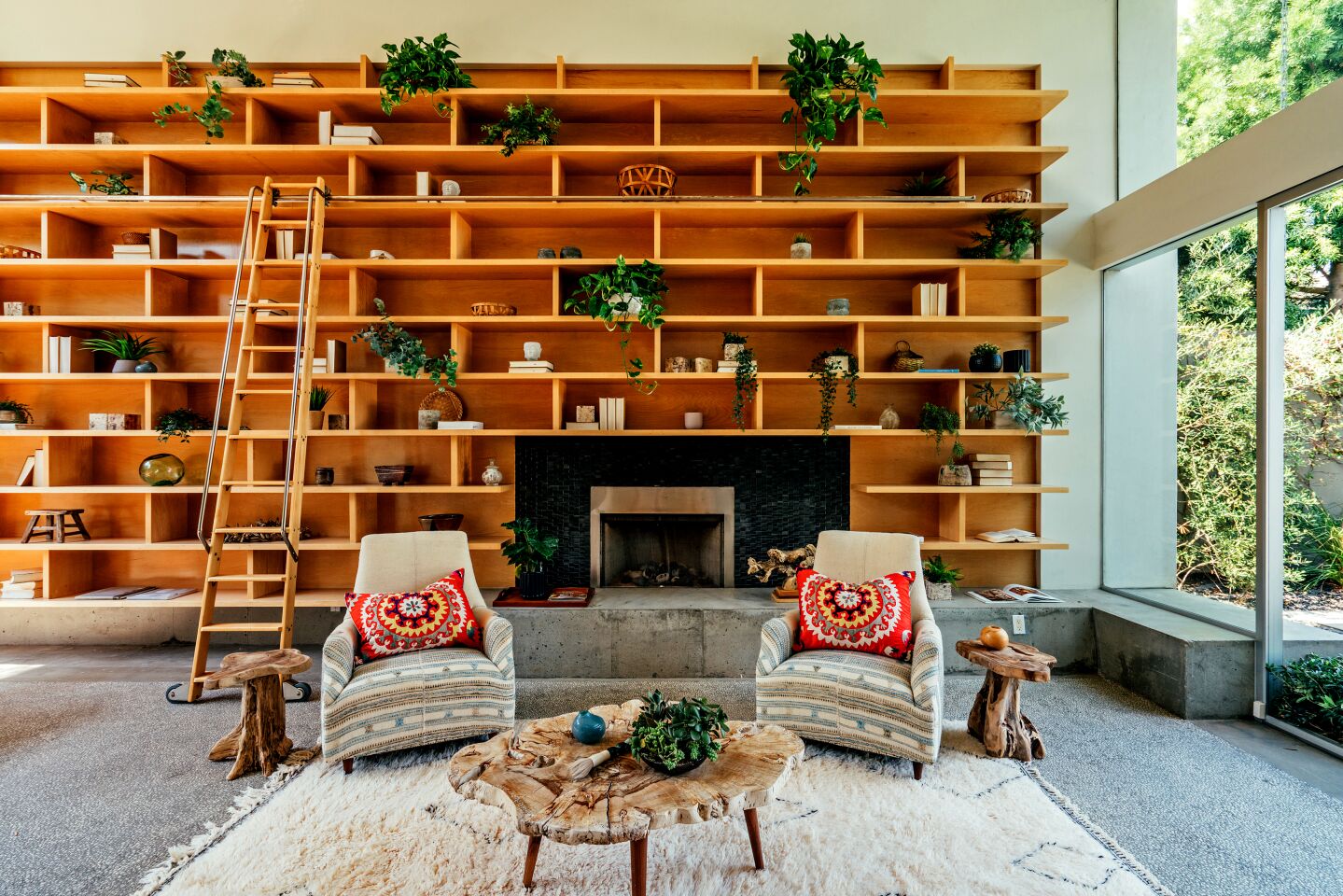 Tucked just off Abbot Kinney Boulevard, the home draws the eye with a dramatic wall of shelves navigated by a sliding ladder.