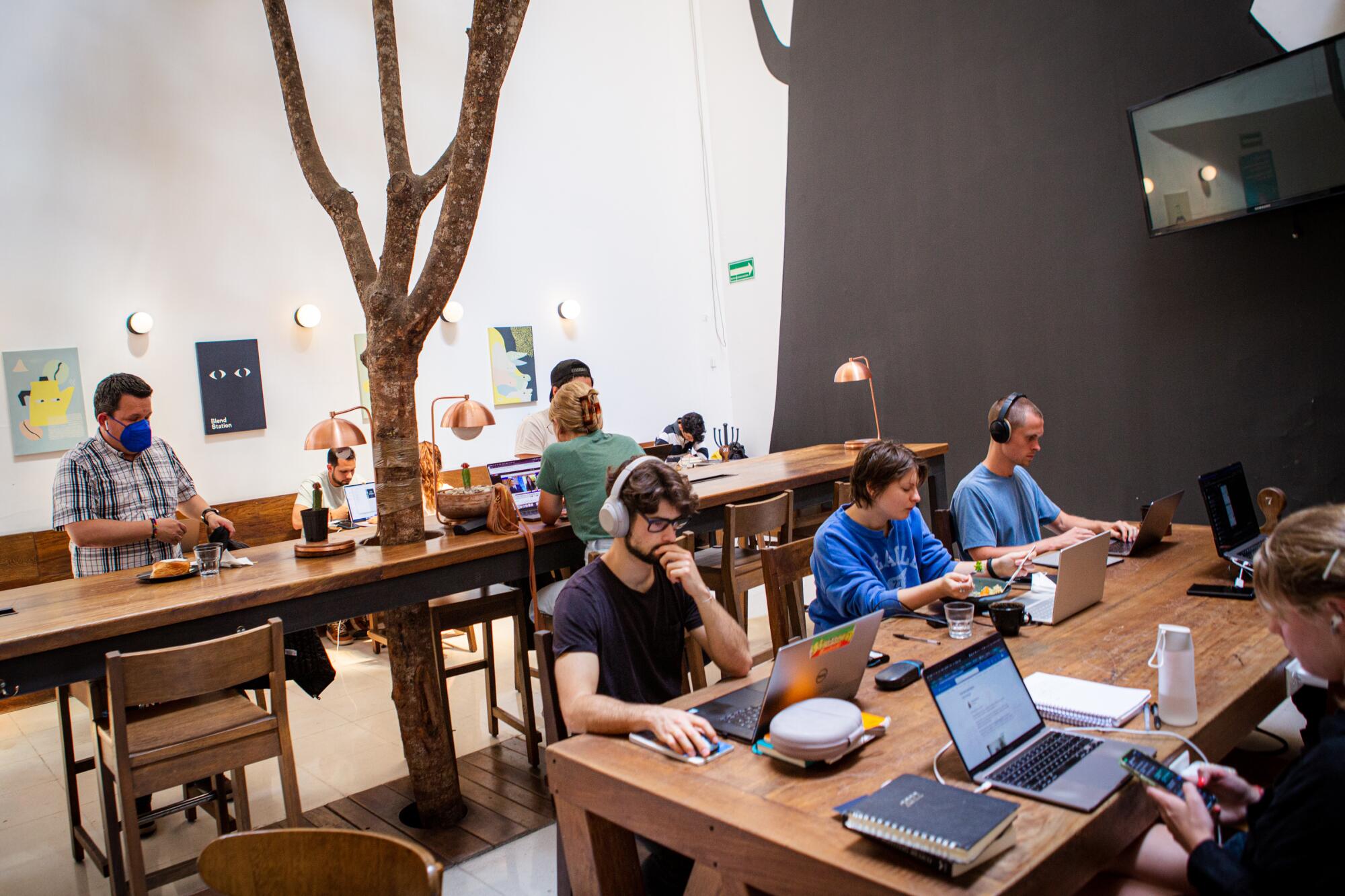 Cafe-goers sit at Blend Station, a coffee shop popular with Americans and remote-workers
