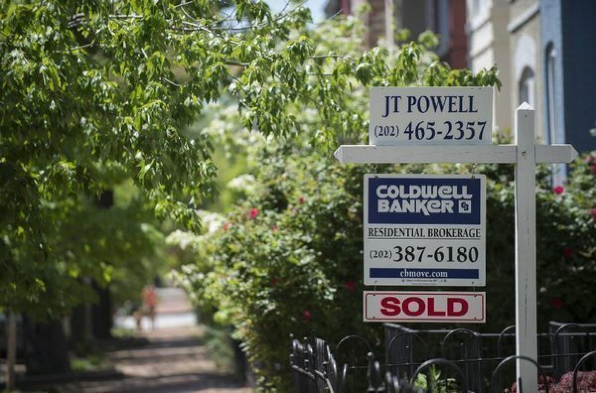 Financially strapped Americans are now about as likely to fall behind on their credit cards as they are on their mortgage, personal credit-rating company TransUnion said. Above, a Washington, D.C., home that was sold earlier this year.