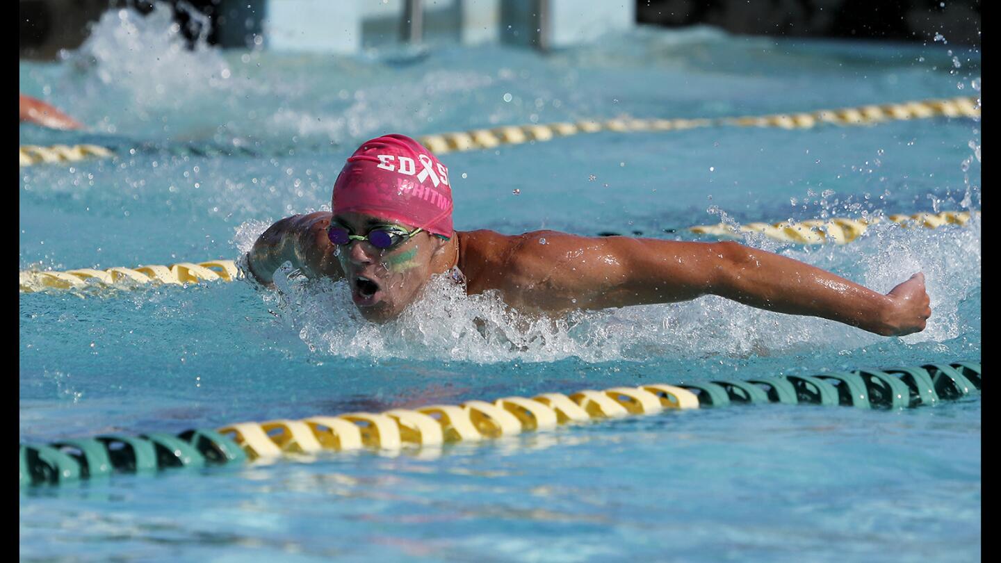 Edison High's Taylor Whitmore competes against Huntington Beach in the boys' 100-yard butterfly race during a Wave League meet at Edison High on Tuesday, April 16, 2019.