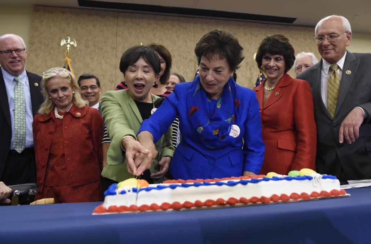 Rep. Doris Matsui, D-Calif., and Rep. Jan Schakowsky, D-Ill., cut a cake to celebrate the 50th Anniversary of Medicare and Medicaid along with their fellow lawmakers on July 29 in Washington, D.C.