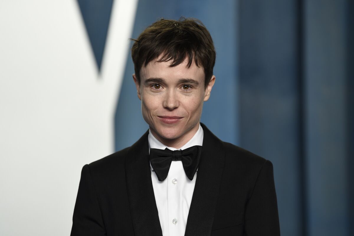 Actor Elliot Page with short brown hair posing in a black tuxedo and bowtie