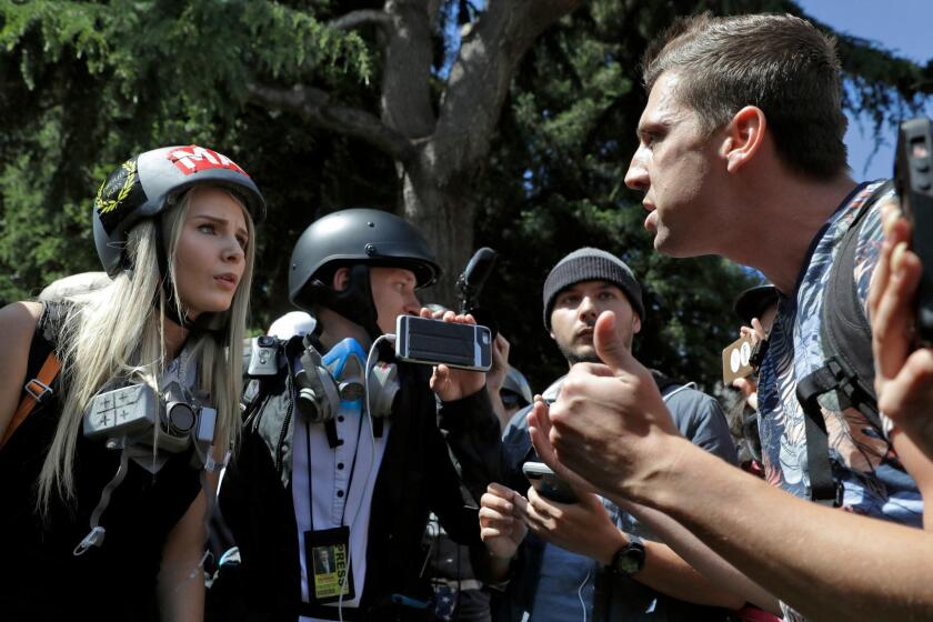 FILE - In this April 27, 2017 file photo, demonstrators, sharing opposing views, argue during a rally in Berkeley, Calif., near the University of California, Berkeley campus, to show support for free speech and to condemn the views of Ann Coulter and her supporters. Coulter's speech was cancelled. Since the beginning of 2016, more than two dozen campus speeches have been derailed amid controversy, according to the Foundation For Individual Rights In Education, a group that monitors free speech on campuses. (AP Photo/Marcio Jose Sanchez, File)