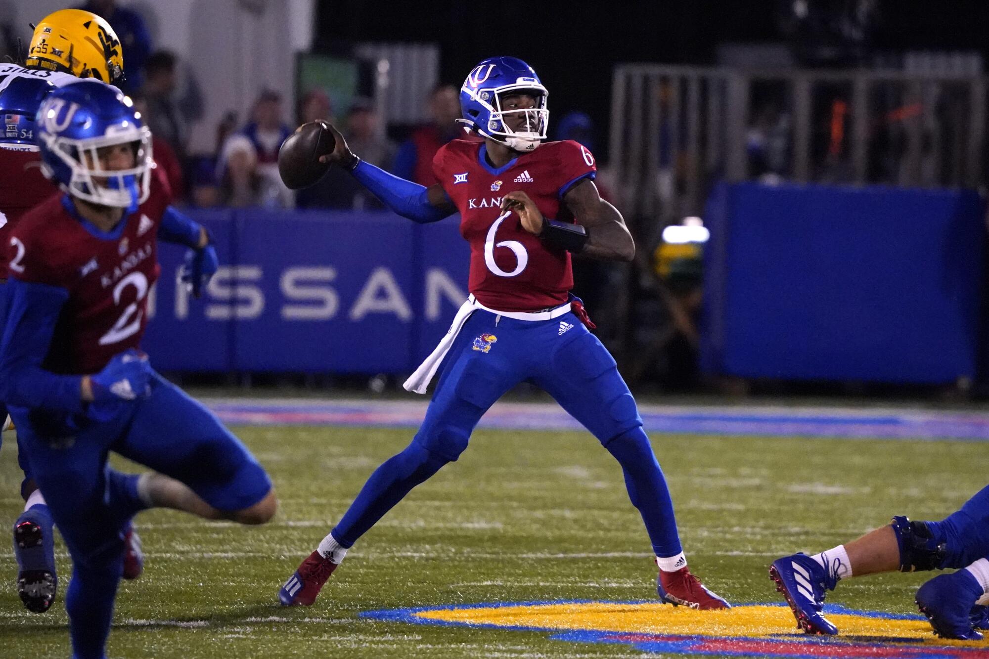 Kansas quarterback Jalon Daniels passes the ball against West Virginia in November 2021.