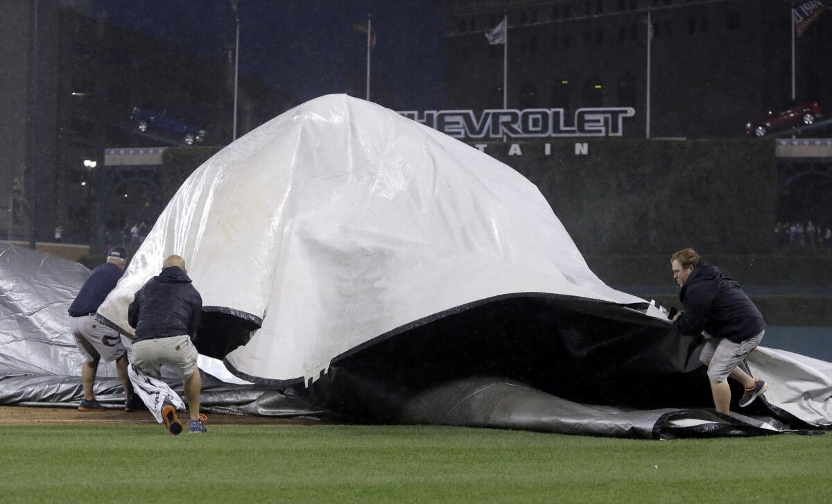 The ground crew at Comerica Park in Detroit loses control of the tarp while trying to cover the field when a severe storm hit during the third inning of the Detroit Tigers' game against the San Francisco Giants.