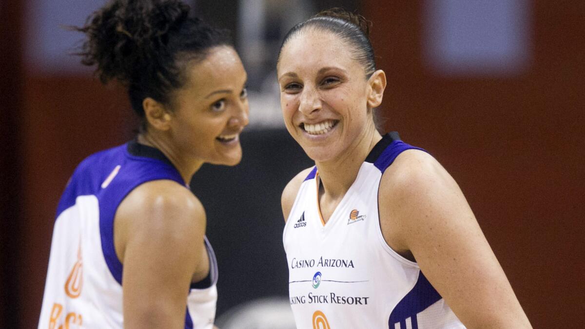 Phoenix Mercury teammates Mistie Bass, left, and Diana Taurasi celebrate after scoring during a game against the San Antonio Silver Stars on May 23.