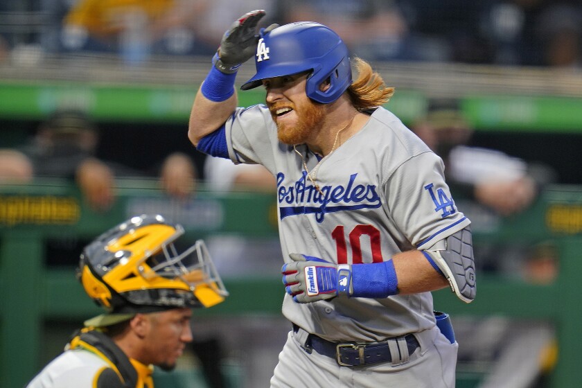 Dodgers' Justin Turner celebrates after crossing home plate after hitting a solo home run.