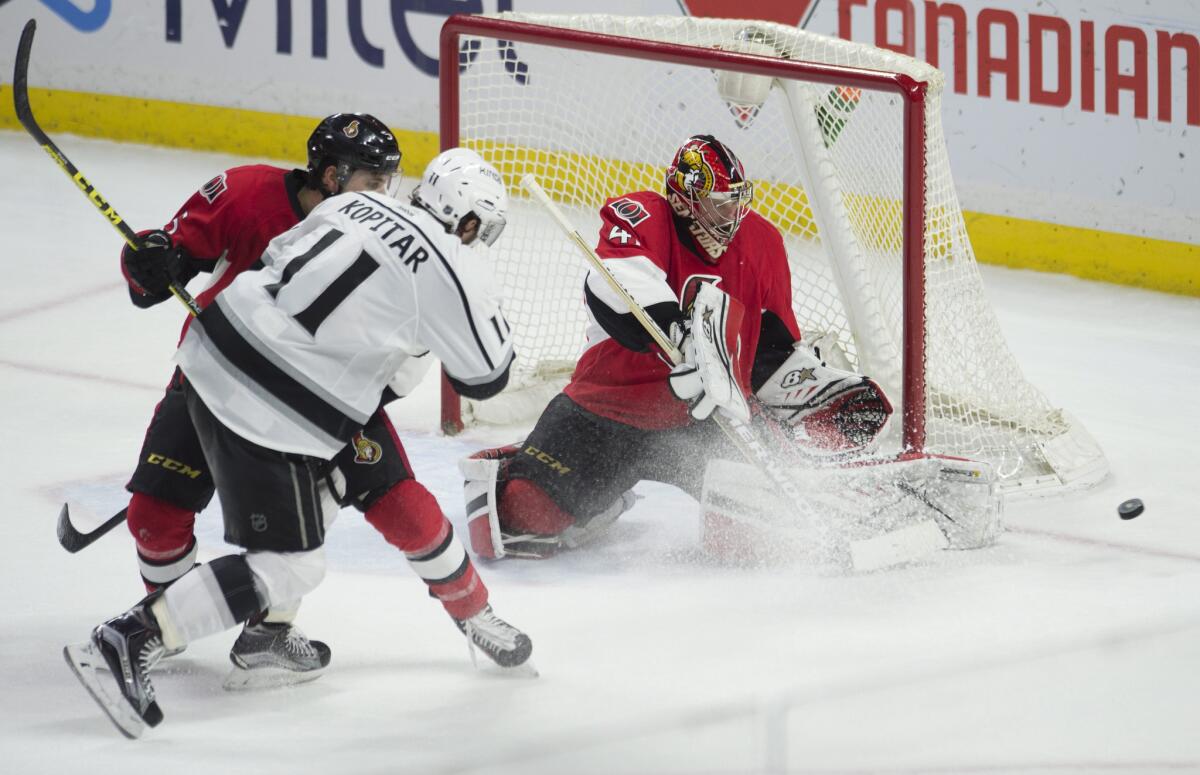 Senators goalie Craig Anderson, right, makes a save on Kings center Anze Kopitar as he is pressured by defenseman Cody Ceci during a Dec. 14 game in Ottawa.