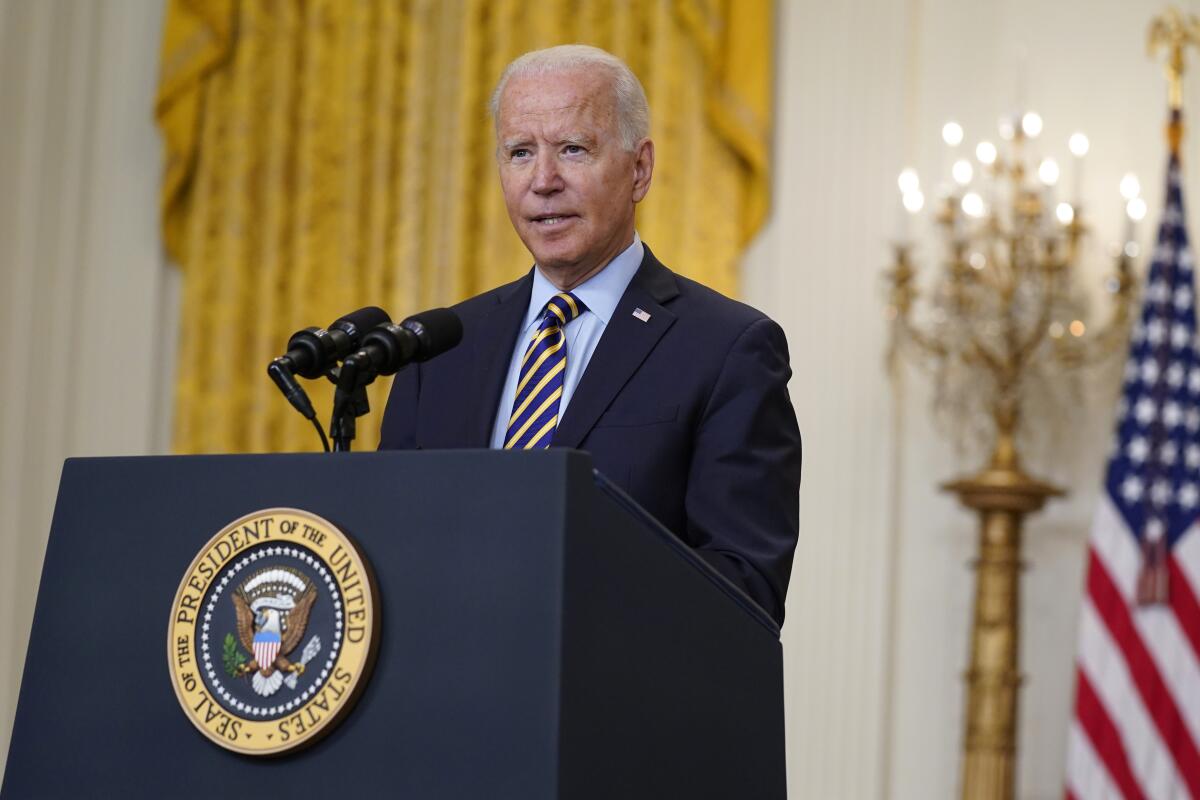 President Biden speaks at a podium at the White House
