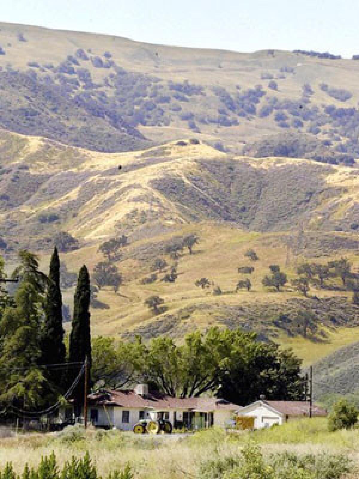 A farmhouse sits near the site of the proposed Newhall Ranch housing development. An L.A. County Superior Court judge has backed alleged flaws in the massive project's environmental review.