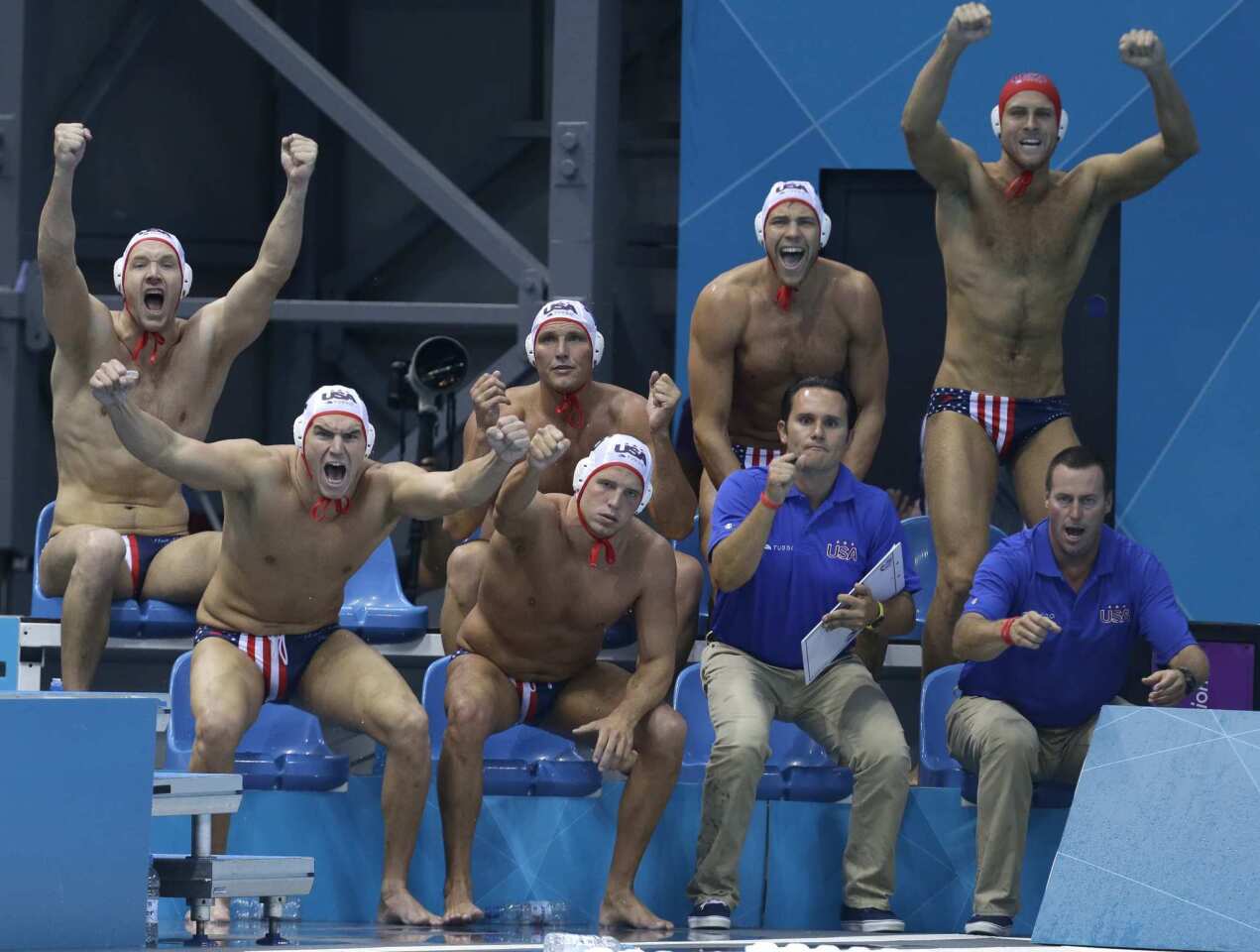United States water polo bench celebrates a goal against Romania.