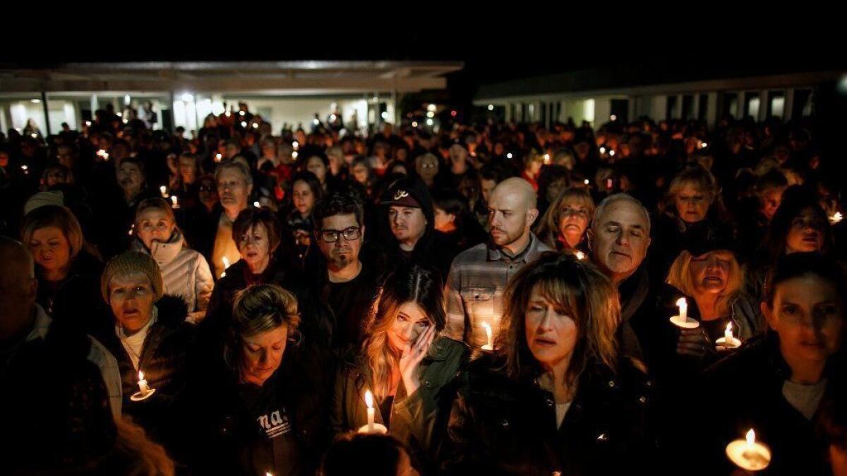 Community members attend a vigil Thursday evening at the Glenknoll Elementary School in Yorba Linda for the four people killed Sunday when pieces of a plane plunged into their home, about an hour before the Super Bowl.