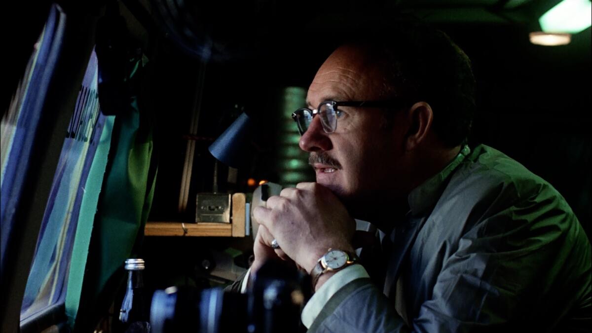 A soundman tapes an exterior recording from a van.