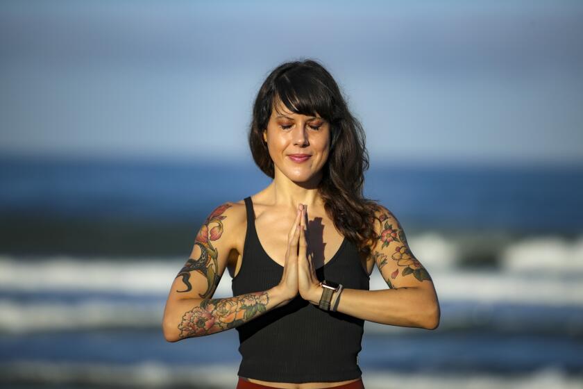 Carlsbad, CA - June 11: A yoga teacher Laura Schwartz in Carlsbad who closed her yoga studio after her business partner embraced conspiracy theories. Schwartz was photographed at beach on Friday, June 11, 2021 in Carlsbad, CA. (Irfan Khan / Los Angeles Times)