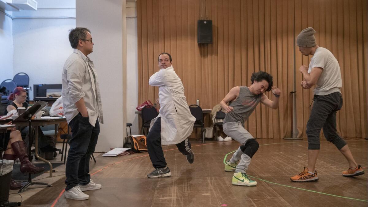 Playwright Qui Nguyen, left, works with "Poor Yella Rednecks" actors, from left, Paco Tolson, Eugene Young and Tim Chiou at South Coast Repertory.