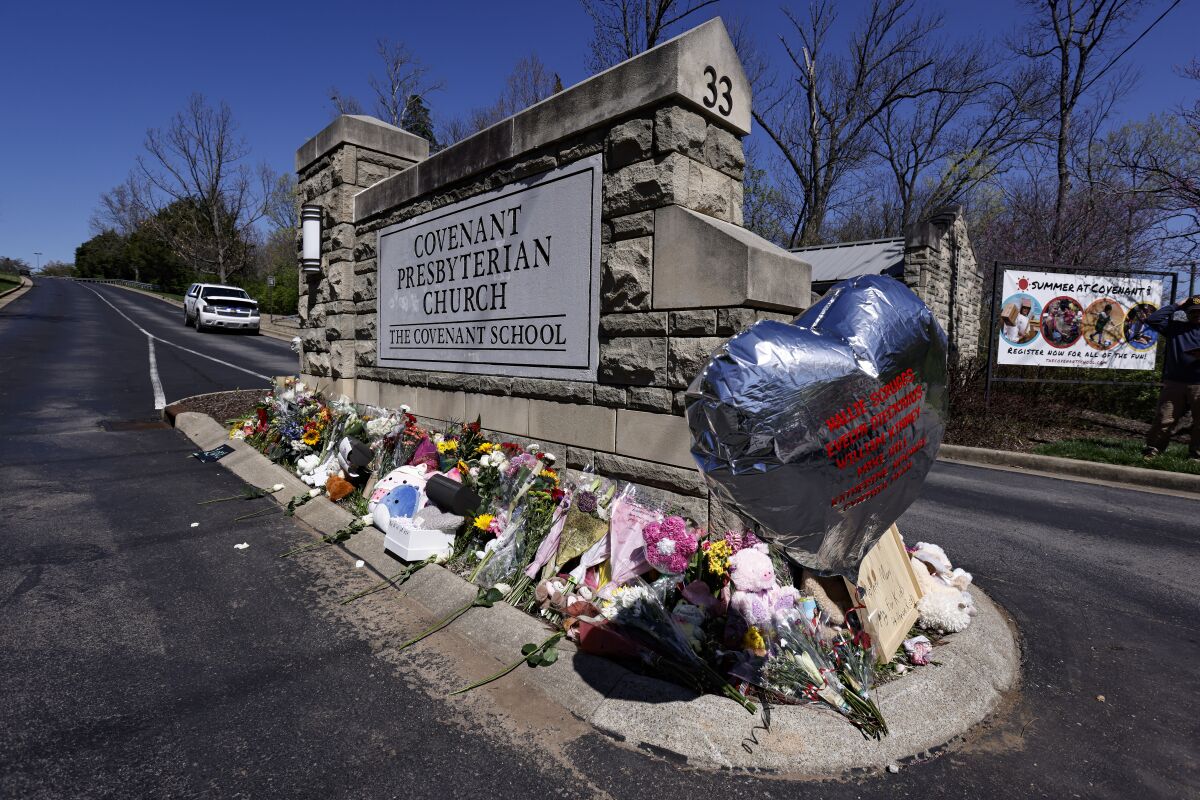 A balloon with names of the victims is seen at a memorial at the entrance to The Covenant School on Wednesday, March 29, 2023, in Nashville, Tenn. (AP Photo/Wade Payne)