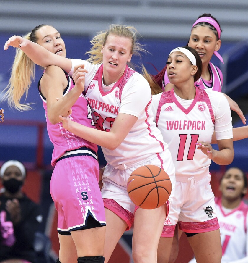 From left, Syracuse Orange forward Digna Strautmane (45), NC State Wolfpack center Elissa Cunane (33) and NC State Wolfpack forward Jakia Brown-Turner (11) vie for a rebound in an NCAA college basketball game in Syracuse N.Y., Feb 28, 2021. (Dennis Nett/The Post-Standard via AP)