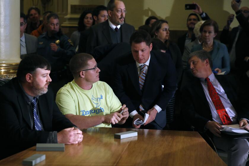 FILE - In this Dec. 19, 2016, file photo, Colorado elector Micheal Baca, second from left, talks with legal counsel after he was removed from the panel for voting for a different candidate than the one who won the popular vote, during the Electoral College vote at the Capitol in Denver. Colorado Secretary of State Wayne Williams, front right, looks on. On Tuesday, Aug. 20, 2019, the 10th U.S. Circuit Court of Appeals ruled that Williams violated the Constitution when he removed Baca from the panel. (AP Photo/Brennan Linsley, File)