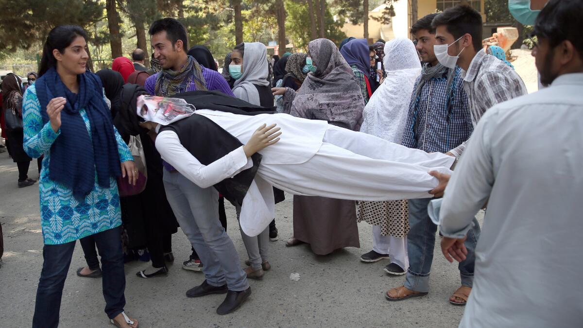 Demonstrators carry an effigy of Gulbuddin Hekmatyar at a protest in a Kabul park.