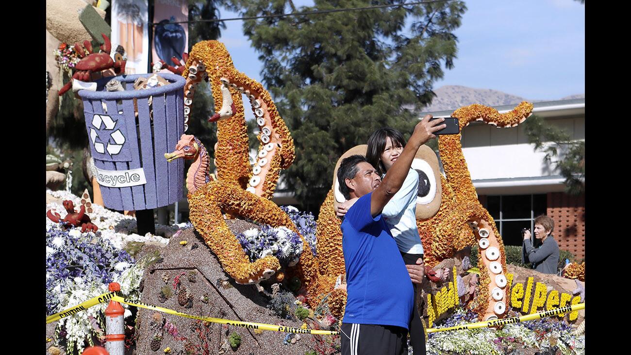Ervin Saaravia and his daughter Samantha take a selfie in front of the "Sand-Sational" Burbank Tournament of Roses float, parked at Olive and Glenoaks for viewing, on Thursday, Jan. 4, 2018.
