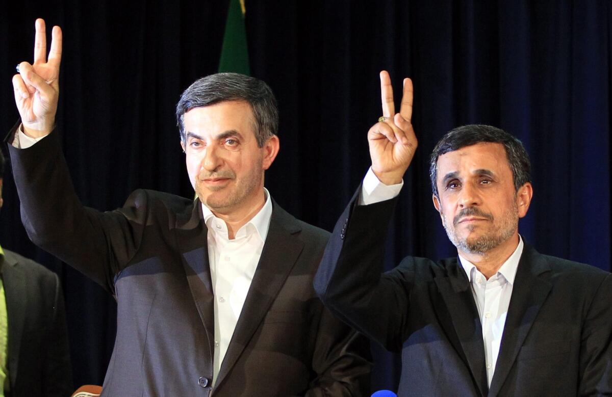 President Mahmoud Ahmadinejad, right, and his confidant, Esfandiar Rahim Mashaei, flash victory signs after Mashaei registered his candidacy earlier this month for Iran's upcoming presidential election.
