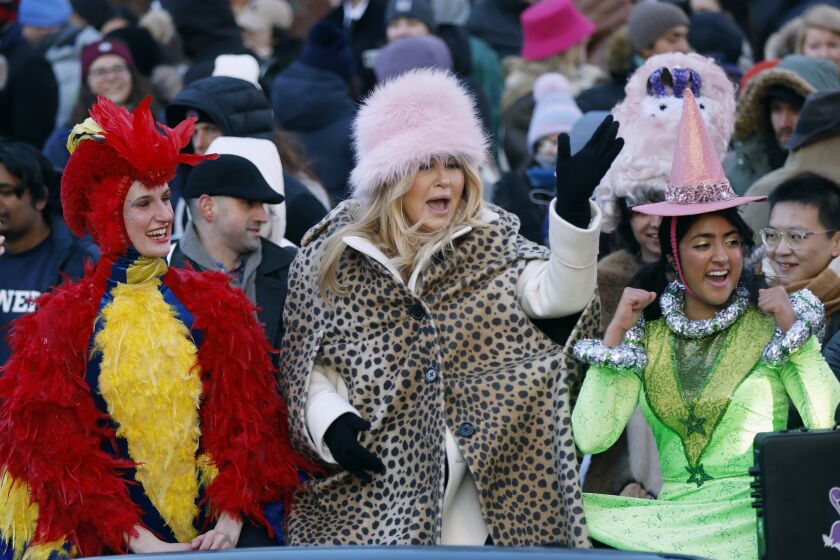 Harvard's Hasty Pudding Theatricals Woman of the Year Jennifer Coolidge, center, rides in a parade in her honor, Saturday, Feb. 4, 2023, in Cambridge, Mass. (AP Photo/Michael Dwyer)