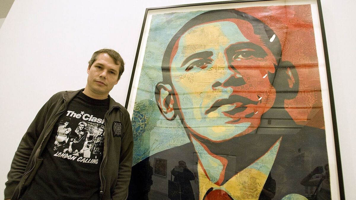 Artist Shepard Fairey poses beside his "Obama HOPE" image in 2009.