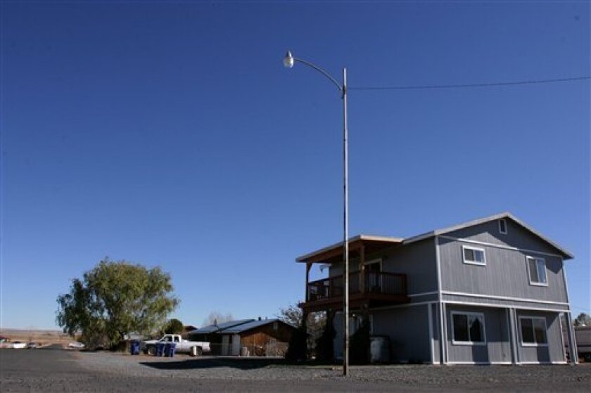 This photograph taken Saturday Nov. 8, 2008 shows the house where Vincent Romero, 29, and Timothy Romans, 39, of San Carlos, Ariz. were found fatally shot in St. Johns, Ariz. on Wednesday. Police say the boy planned and meticulously carried out the shootings, but they haven't discussed a motive. (AP Photo/Dana Felthauser)
