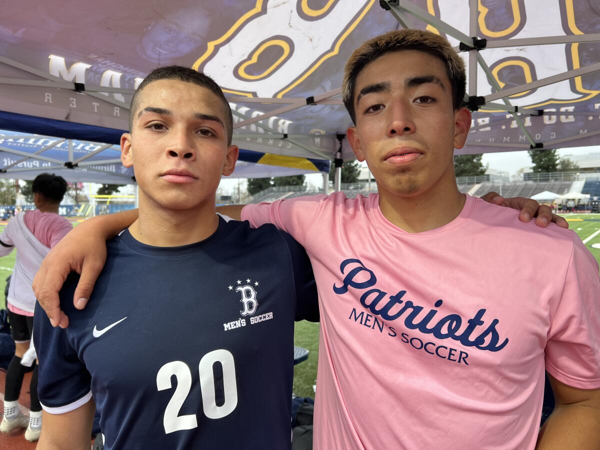 Jerry Ramos (left) scored four goals and Oscar Vargas pose for a photo with arms wrapped around each other's shoulders.