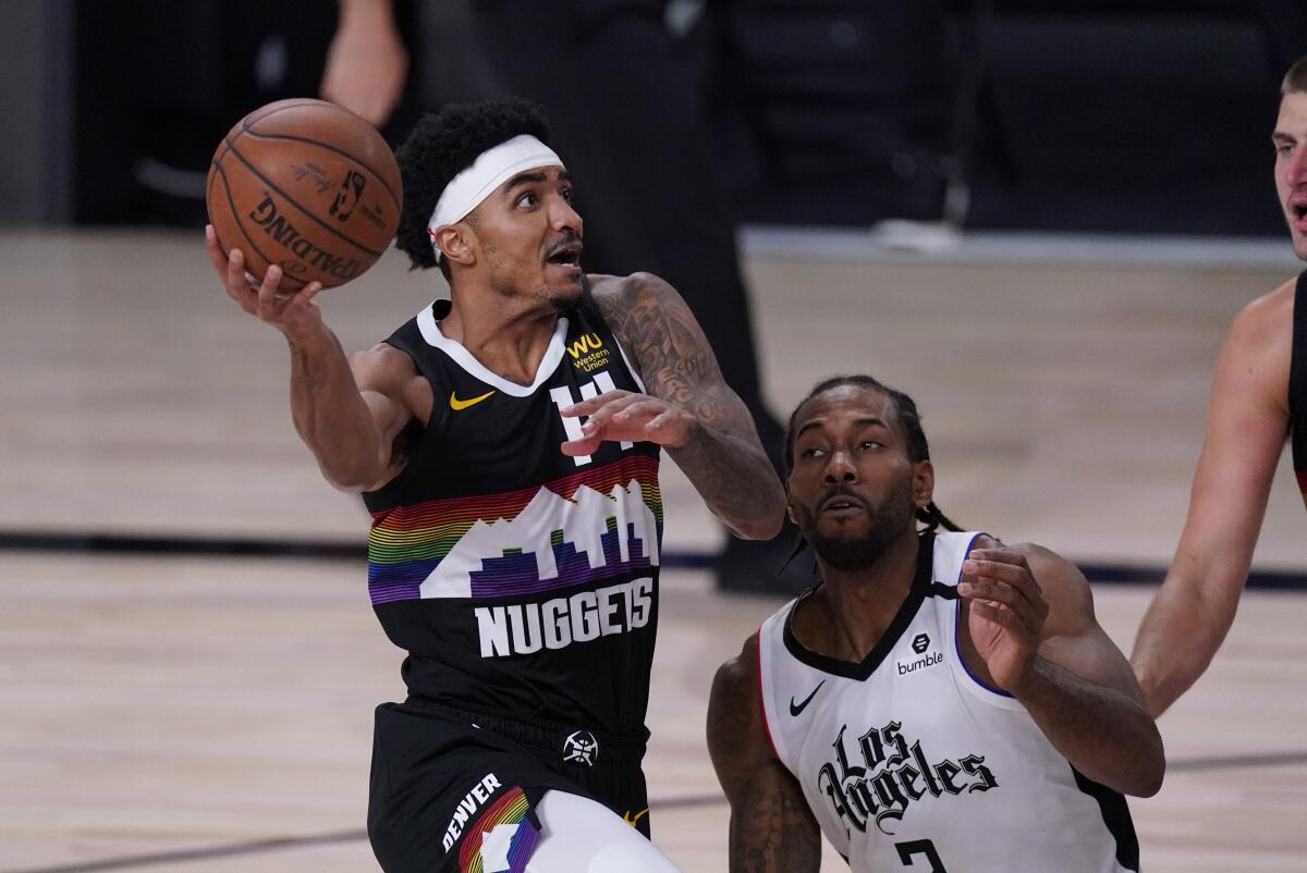 Nuggets guard Gary Harris tries to score against Clippers forward Kawhi Leonard during the second half of Game 4.