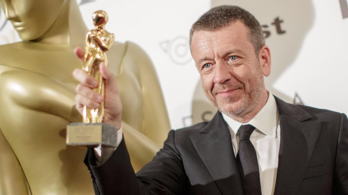 Peter Morgan holds up his Romy Award in Vienna, Austria on April 22.