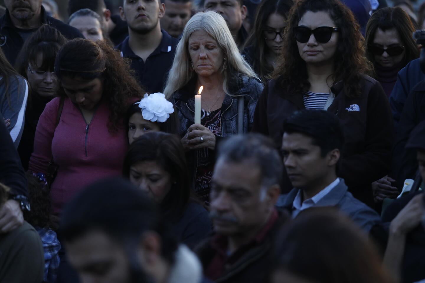 People attend a vigil for fallen Pomona Police Officer Greggory Casillas at the Pomona Police Department on Sunday evening.