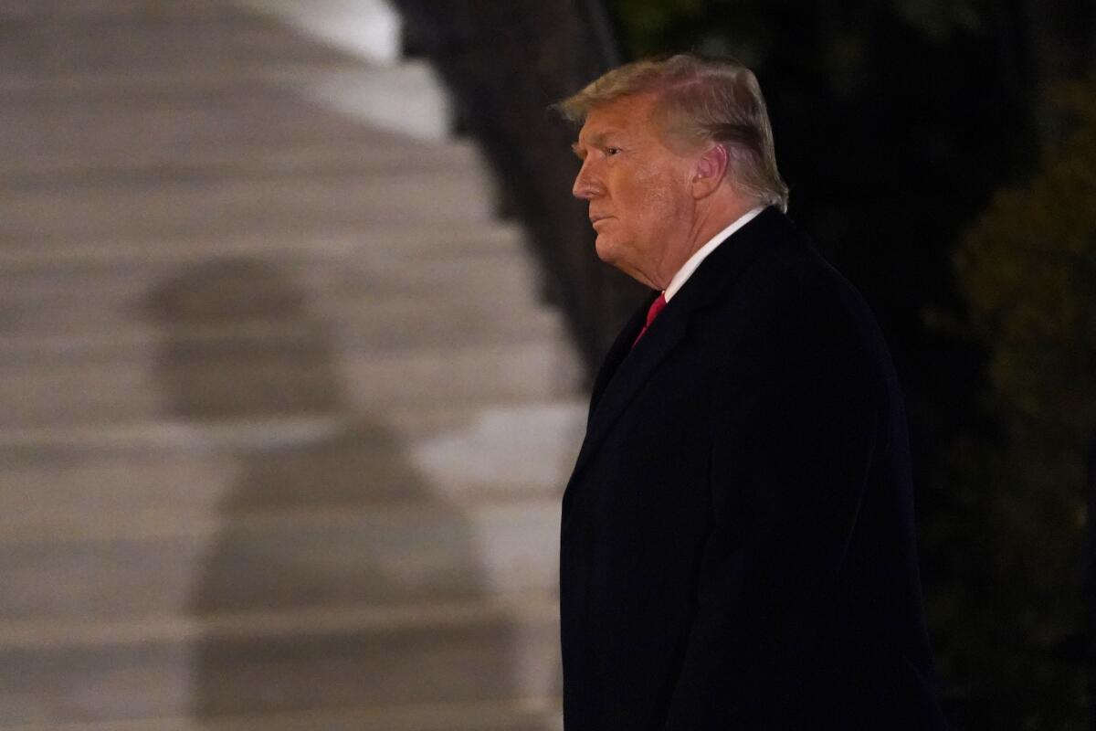 President Trump arrives at the White House on Tuesday evening after a trip to Texas.