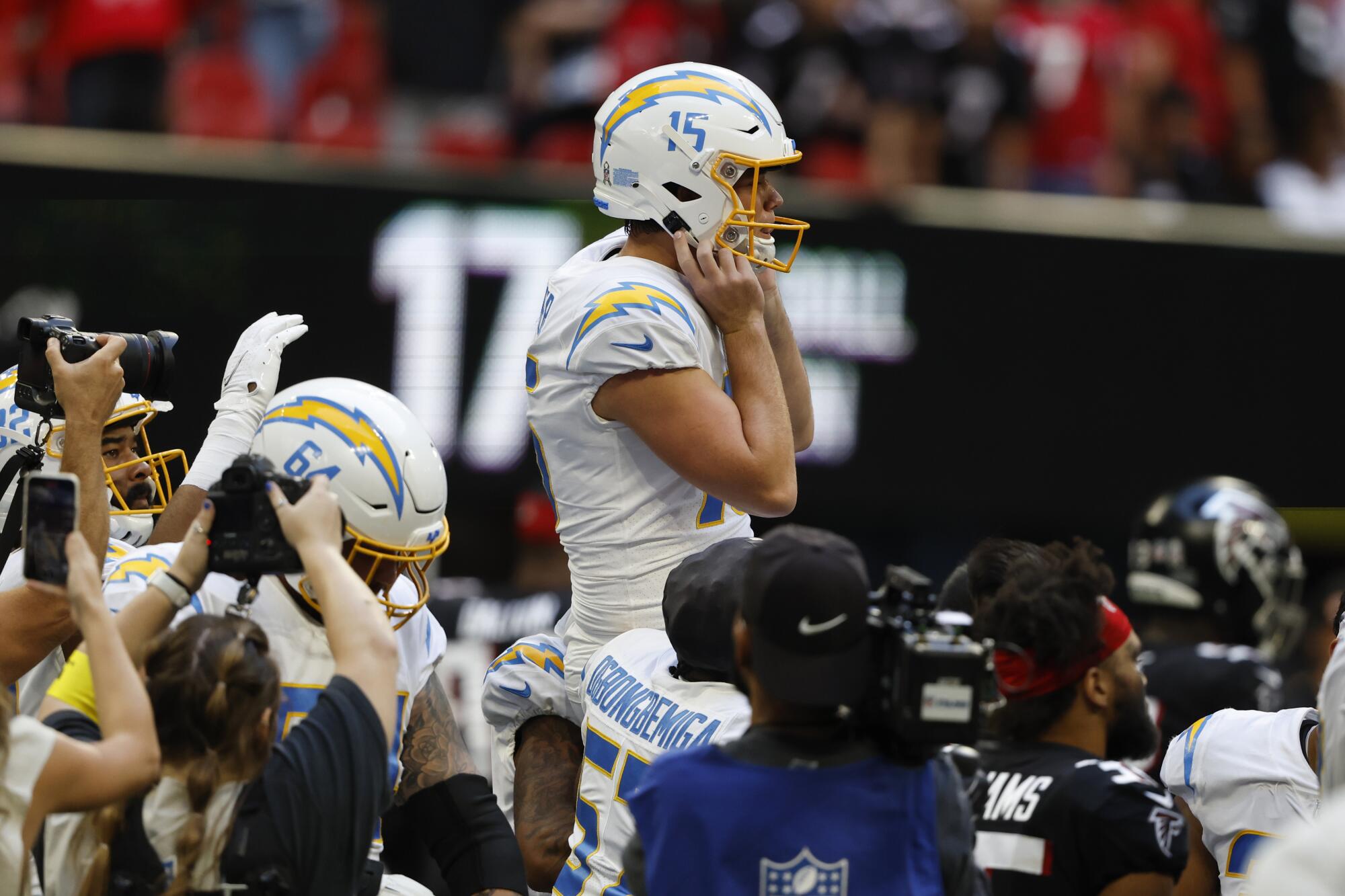 Chargers kicker Cameron Dicker is carried by teammates after making a 37-yard field goal.