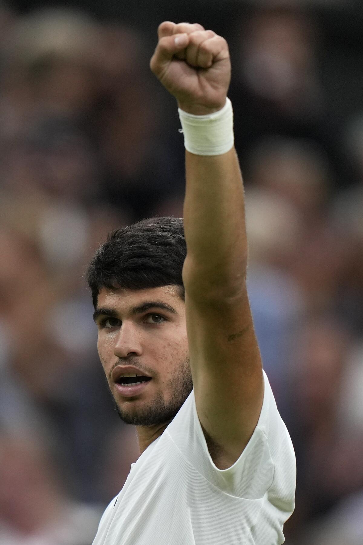 Carlos Alcaraz celebrates after beating Russia's Daniil Medvedev in a Wimbledon men's singles semifinal match Friday.