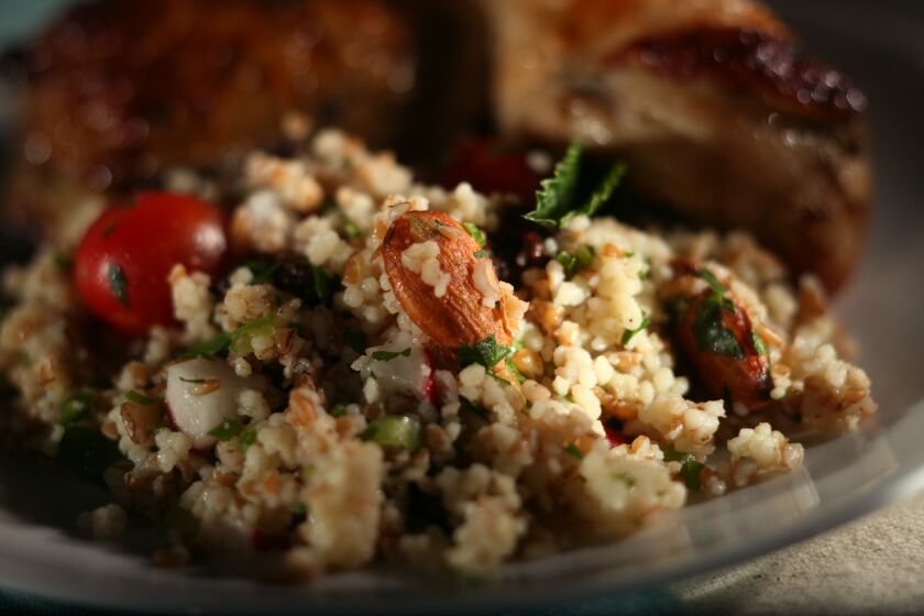 Houston's couscous is made with couscous, bulgur wheat, radishes, parsley, green onions, raisins, tomatoes, almonds and mint. Recipe
