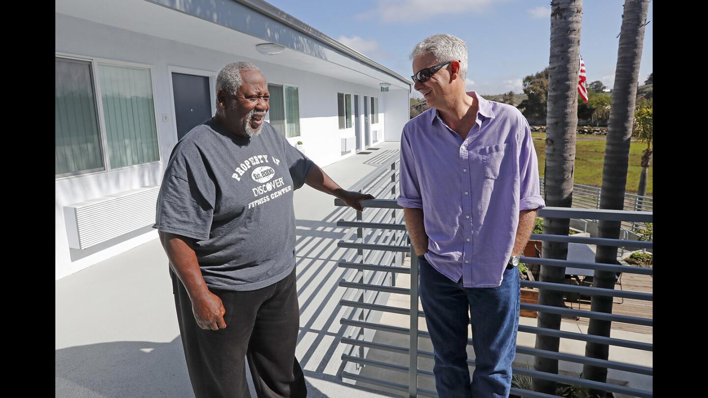 Donald Gates, 77, left, site manager and resident, shares a laugh with Larry Haynes, Mercy House executive director, as they talk at The Cove Apartments in Newport Beach on Friday, March 23. The Cove Apartments provides permanent affordable and supportive housing for homeless veterans and low-income seniors age 62 and older earning 30-60 percent of the area median income.