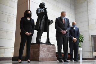 Standing near a statue of Frederick Douglass, Sen. Kamala Harris, D-Calif., left, Senate Minority Leader Sen. Chuck Schumer of N.Y., center, and Sen. Cory Booker, D-N.J.,, right, pause during a prayer Capitol Hill in Washington, Thursday, June 4, 2020, during an event to commemorate the life of George Floyd, who died after being restrained by Minneapolis police officers. (AP Photo/Susan Walsh)