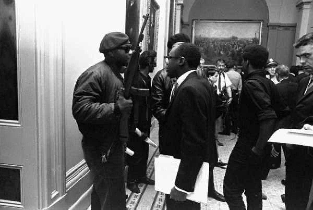 In May 1967, Black Panthers protesting an Assembly bill to ban openly carrying loaded weapons showed up at the state Capitol with unloaded firearms. That's a young Willie Brown, future Assembly speaker, talking with a Panther.