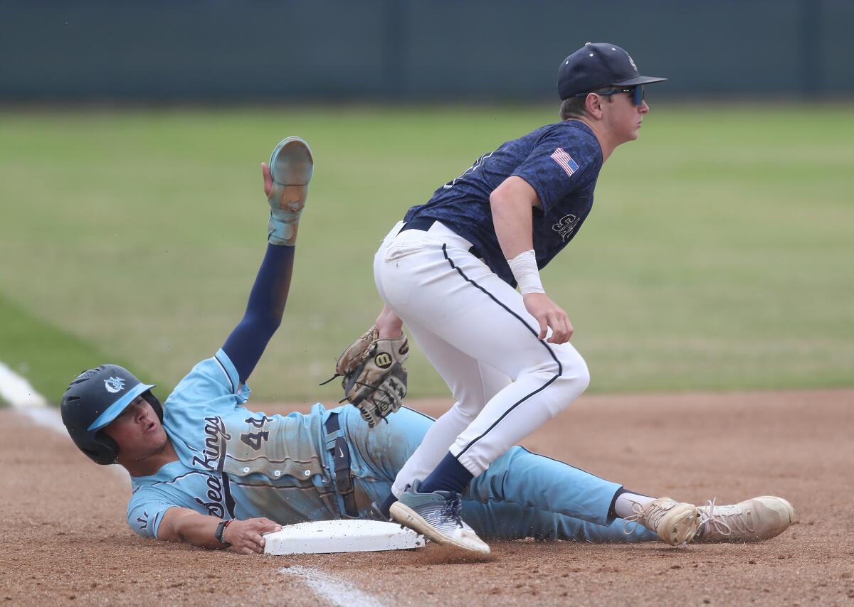 Newport Harbor's Wyatt Gahm tags CdM's Carter Danz for an out on a close play at third base during Friday's game.