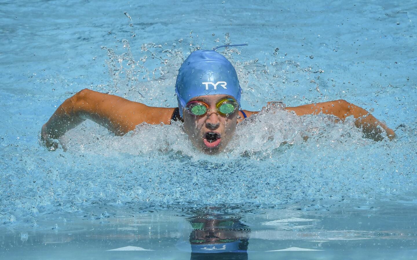 Clemens Crossing's Robin TenHoor tears through the water as she swims in the girls 15-18 50 yard butterfly during the Columbia Neighborhood Swim League meet between host Clemens Crossing and Harper's Choice Saturday morning in Columbia.