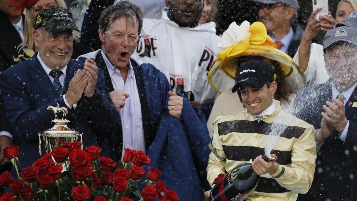 Jockey Flavien Prat celebrates after riding Country House to victory at the Kentucky Derby on May 4.