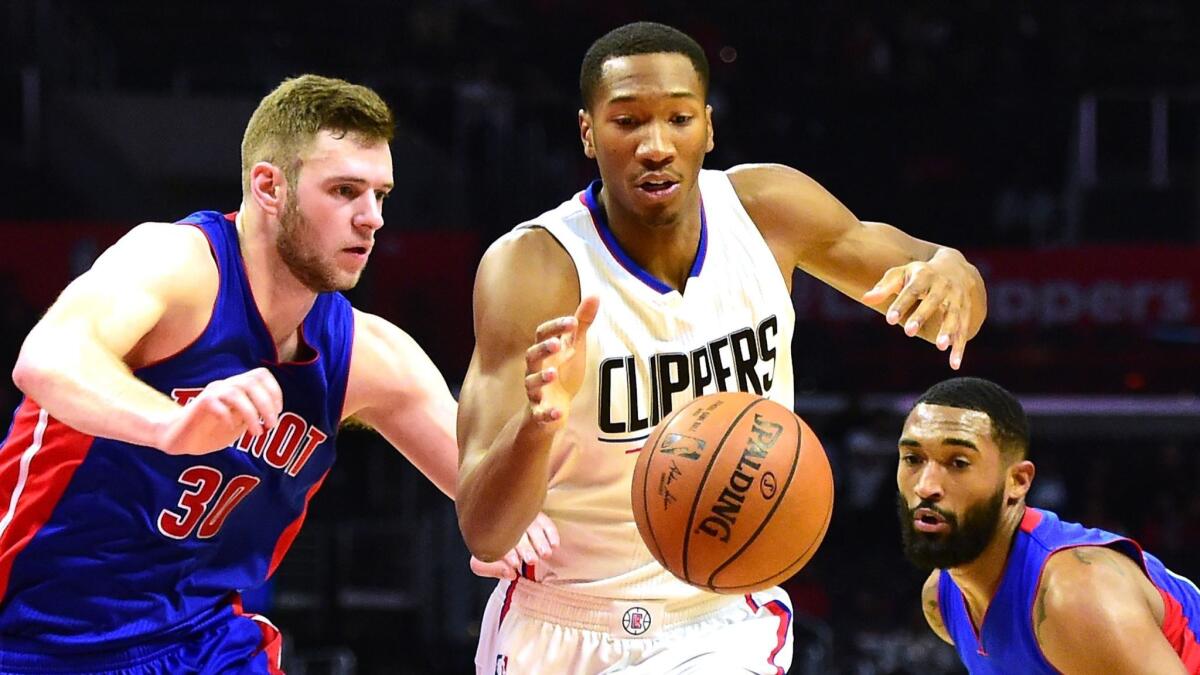 Clippers' Wesley Johnson tries to get past Detroit's Jon Leuer, left, and Andre Drummond on Nov. 7.