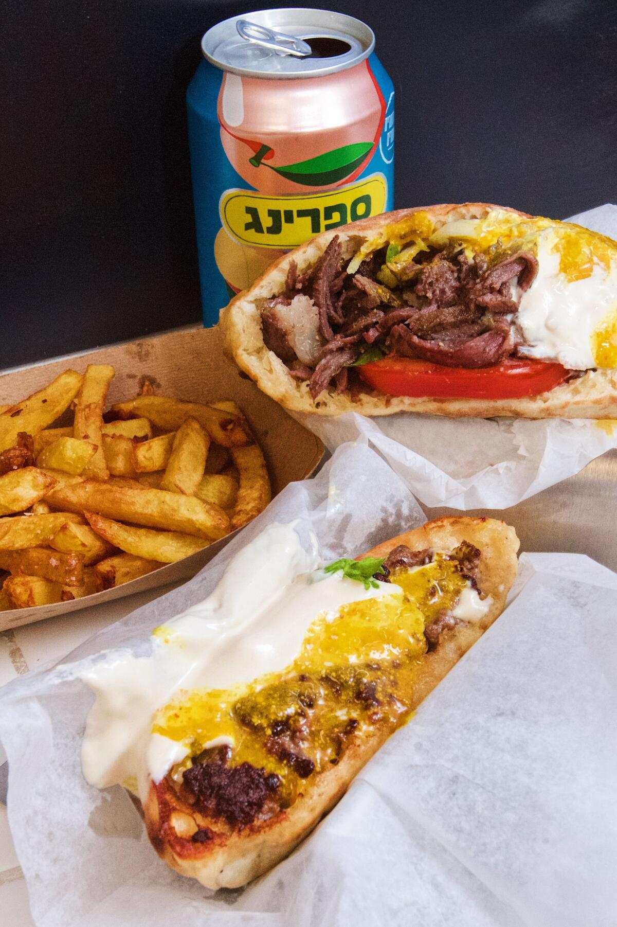 A wagyu shawarma, arayes, side of French fries and a can of Israeli juice.