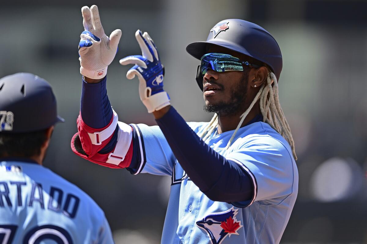 Toronto Blue Jays' Raimel Tapia celebrates after hitting a two-RBI single during the second inning in the first baseball game of a doubleheader against the Cleveland Guardians, Saturday, May 7, 2022, in Cleveland. (AP Photo/David Dermer)